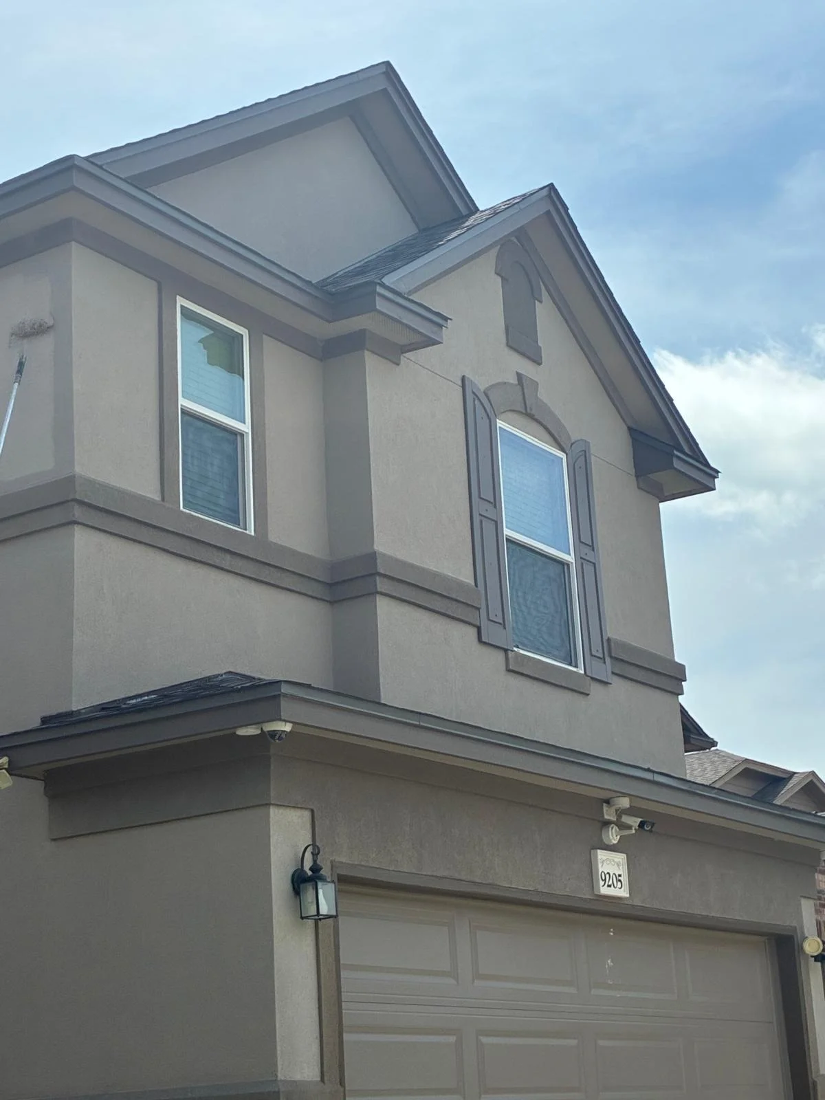 Exterior residential home showing roofline, gutters, and fascia details in daylight.