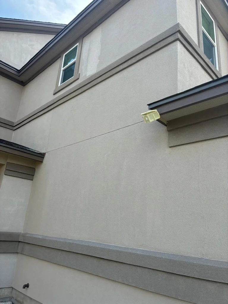 Exterior wall with soffit, fascia, and gutter system installation on a residential home.