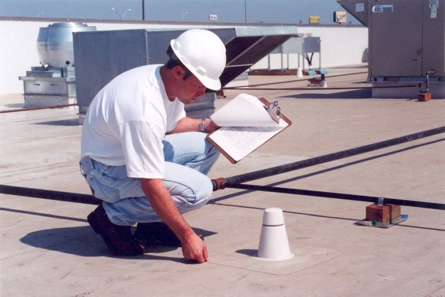 Flat roof leak inspection on a low-slope roof in Central Texas