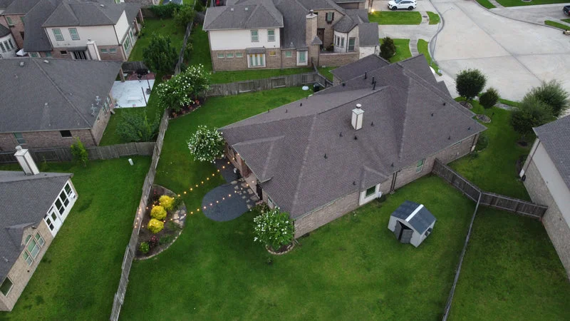 Aerial view of completed Class 4 IKO Nordic roof replacement on a suburban home in Sugar Land, TX