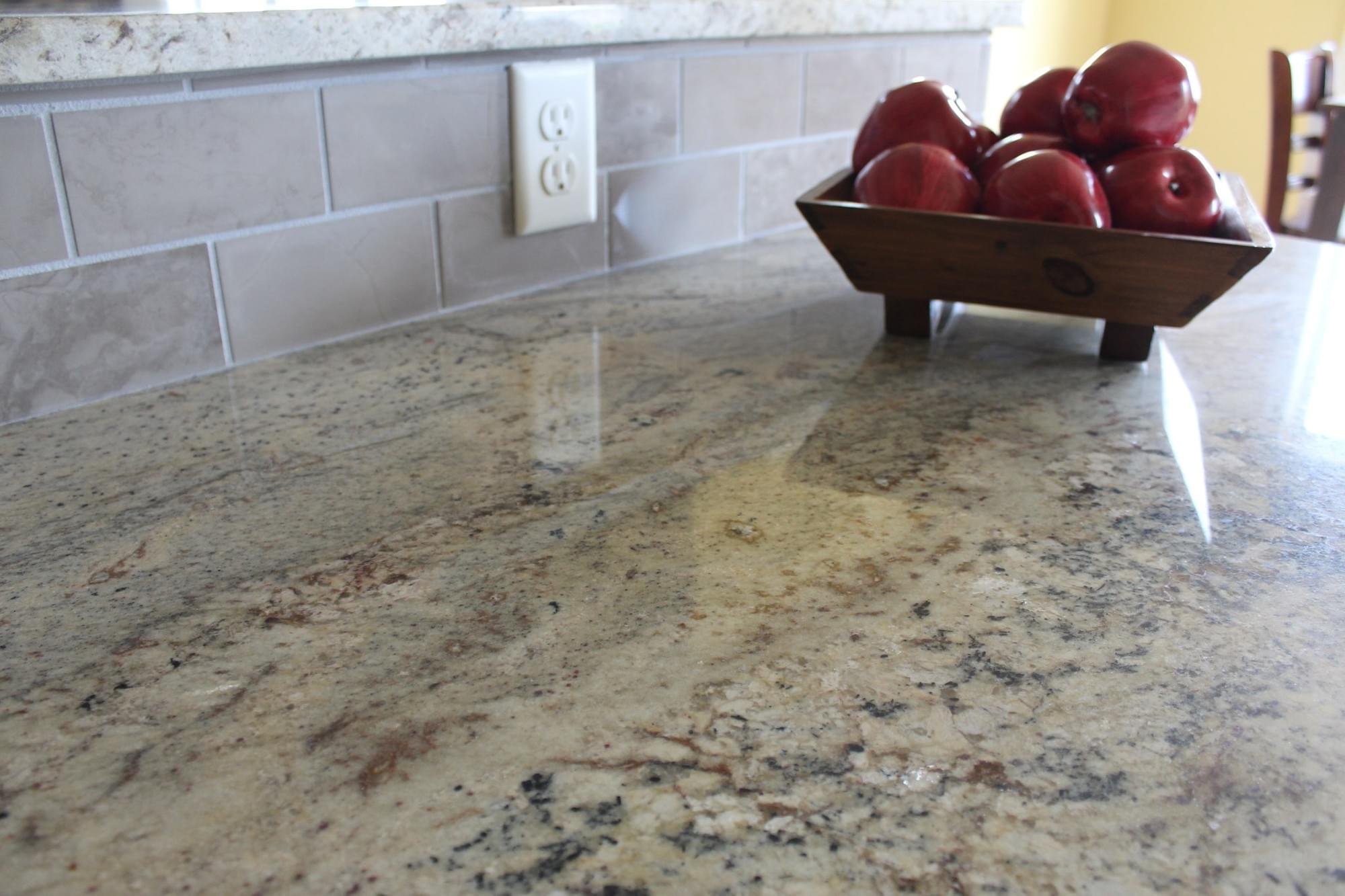 Warm granite countertop with light backsplash